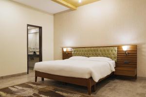 a bedroom with a large bed and a large mirror at Park Inn By Radisson Amritsar Airport in Amritsar +51 photos