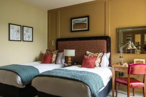 Postel nebo postele na pokoji v ubytování The Alma Hotel