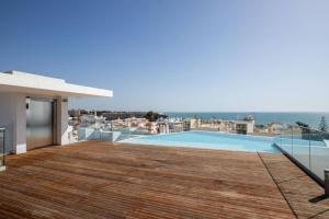 a view from the balcony of a house with a swimming pool at New 2bedroom Apartment w Terrace & Infinity Pool in Olhos de Água