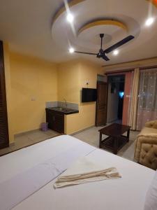 a bedroom with a bed and a living room at Seko Haven Resort in Kilifi