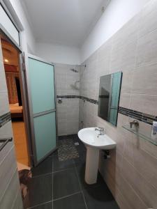a bathroom with a sink and a mirror and a shower at Seko Haven Resort in Kilifi