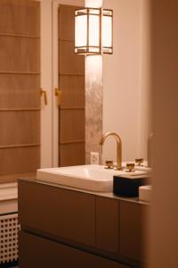 a bathroom with a sink and a mirror at MEWS House Zürich in Zürich +1 photo