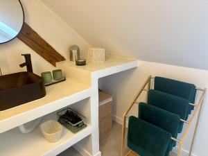 een badkamer met twee blauwe stoelen en een wastafel bij Appart Saint Jo in Colmar