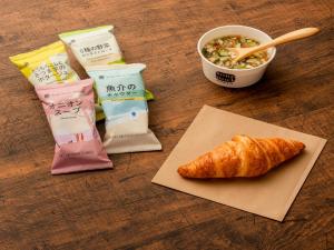 a table with a bowl of food and a croissant at Hotel Resol Ueno in Tokyo
