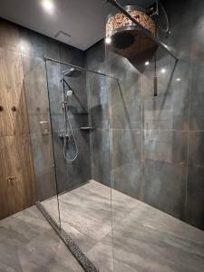 a bathroom with a shower with a glass door at Готельний комплекс GАРБУЗ in Zwiahl