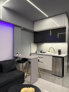 a kitchen with a couch and a table in a room at Crystal Grey Elite Apartment 2 in Serres