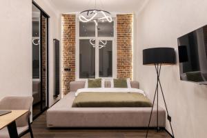 a bedroom with a bed in front of a window at Rynok Square Pidzemelya in Lviv