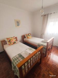 a bedroom with two beds and a window at Vergikosk House - villa 4 quartos com piscina privada in Bombarral