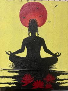 a painting of a woman sitting in a meditation pose at KKOZY NOOk in Aurangabad