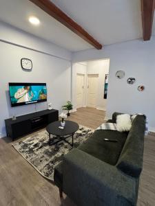 a living room with a couch and a tv at The Vantage in Lusaka