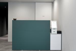 a blue wall with a machine and a microwave at Morf Stay in Seoul