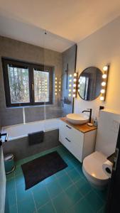 a bathroom with a tub and a toilet and a sink at Dachstein104 in Bad Goisern +41 photos