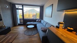 a living room with a couch and a table at Dachstein104 in Bad Goisern