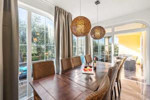 RošiniHoliday House with Private Pool Villa Seabird的配有木桌椅的餐厅