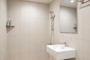 a white bathroom with a sink and a mirror at Morf Stay in Seoul
