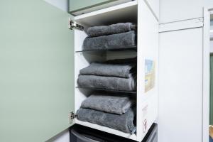a stack of towels in a closet at yadobankharuyoshi201 in Fukuoka