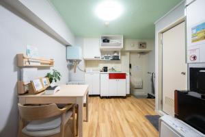 a small apartment with a desk and a kitchen at yadobankharuyoshi201 in Fukuoka