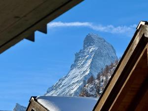 a view of the matterhorn mountain from a building at Peaky Riders Self Check-in Hotel in Zermatt