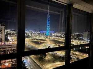 a view from a window of a city at night at Fabuloso Hotel Alvorada - Apt da Rede Premium in Brasilia