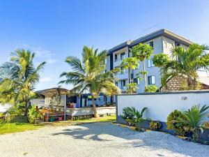 a house with palm trees in front of it at Diani beachview escape in Ukunda