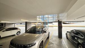 two cars parked in a parking lot in a building at SOlaz Smart Living Manaira in João Pessoa +14 photos
