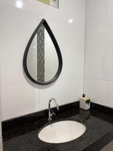 a bathroom sink with a mirror on the wall at Quarto privado próximo ao centro 10 in Manaus