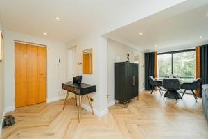 a living room with a desk and a table at Eagleside Apartments in Auchterarder
