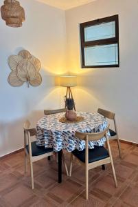 a dining room table with chairs and a lamp at Flora Apartment - near the sea in Bar, Susanj