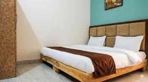 a bedroom with a large bed with a blue wall at Nilaya in Varanasi