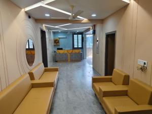 a waiting room with couches and a mirror at Hotel Metro in Himatnagar