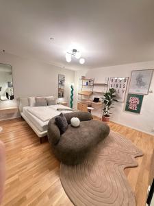 Modernes City Apartment inkl Garage und Balkon في لينز: غرفة معيشة بها سرير وأريكة كبيرة