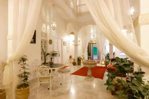 a living room with a table and some plants at Riad Morocco Sky in Marrakech