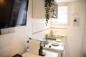 a kitchen with a sewing machine on a counter at Charmant Studio avec parking Résidence Zénith in Caen