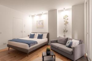 a bedroom with a bed and a couch at The Golden Studio by Aura Luxury Collection in Como