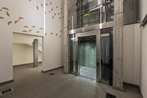 a hallway with birds flying around a building at The Golden Studio by Aura Luxury Collection in Como