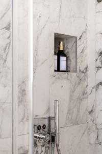 a bathroom with a mirror and a bottle of soap at The Golden Studio by Aura Luxury Collection in Como