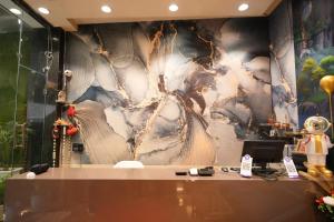 a room with a wall with a painting on it at SRT Rajmahal Famliy Hotel Luxa RoadVARANSHI in Varanasi