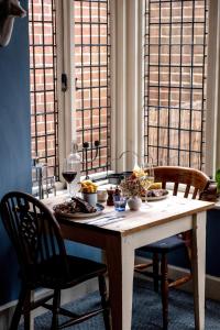 a table with food and glasses of wine on it at The Royal Oak in Hawkhurst +28 photos