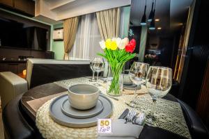 a table with plates and wine glasses and flowers on it at LM50L2 horizon101 cebu in Cebu City