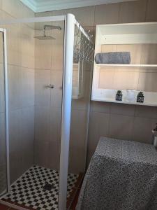 a shower with a glass door in a bathroom at 4 On Susanna in Kimberley