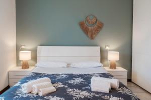 a bedroom with a bed with two pillows and two lamps at I Lavatoi Iseo - apartment in Iseo