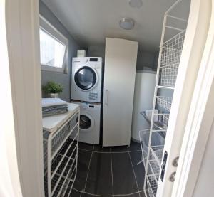 a laundry room with a washing machine and a washer at Modern condominium in Bergen +17 photos