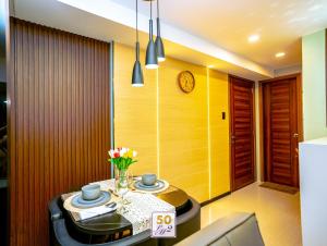 a dining room with a table and a clock on the wall at LM50L2 horizon101 cebu in Cebu City +28 photos