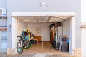 a room with a bike parked under a garage at Casa Oceano-Mar a vista in Raposeira