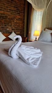 Ένα ή περισσότερα κρεβάτια σε δωμάτιο στο Mayong Bali Homestay And Resto