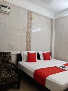 a hotel room with two beds and a chair at SMS GRAND inn in Chennai +44 photos