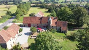 an aerial view of a large house with a yard at Chateau De Montmagner in Arnac-la-Poste
