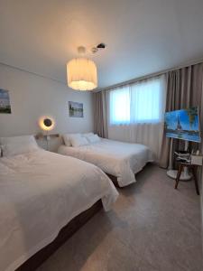 Ένα ή περισσότερα κρεβάτια σε δωμάτιο στο 스테이소담소담