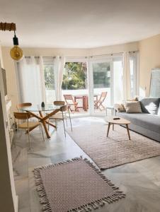 a living room with a couch and a table at Pinos de Calahonda duplex in Sitio de Calahonda