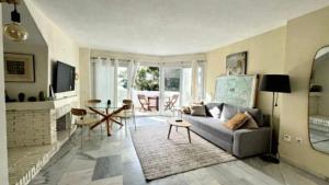 a living room with a couch and a table at Pinos de Calahonda duplex in Sitio de Calahonda
